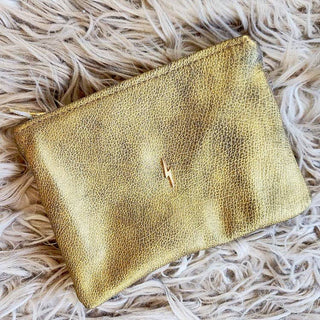 Supple Golden Bolt Pouch - Holt x Palm -  This Pouch is crafted from superior supple Italian Leather with a gold bolt accent for a stylish touch. Lined with plush rust velvet and features an heavy duty Italian zipper for added durability. The pouch also features a small, interior pocket for extra organization. Approximate Dimensions 7.75" W x 6"H