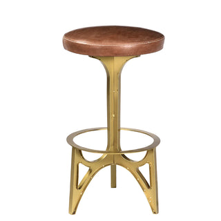 Ersa Bar Stool - Holt x Palm -  The Ersa Stool offers a new spin on the tripod style base, something rarely done for a bar or counter stool. The brass-finished iron base is three connected sections completed by the addition of the round foot rest and the stool seat. The round Ersa Stools are upholstered in a brown leather to complete the enduring look. 16€� dia x 30€�