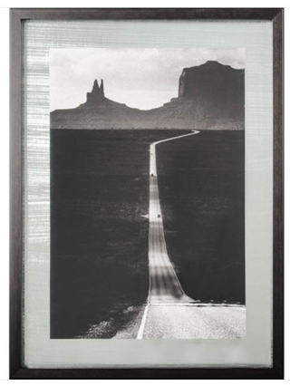 Off the Beaten Path Framed Artwork - Holt x Palm -  Get lost in a daze with the black and white deserted road artwork! You can stare at the road for hours and see things you didn't realize were there. With an ominous mountain range off in the distance, you can imagine what is on the other end. Artist Strand, HakanProduct Size (Inches) 28.0L x 1.8W x 38.0HWeight 25.00 lbs