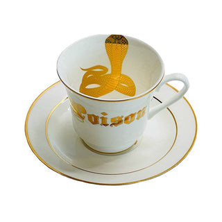 Poison Tea Cup - Holt x Palm -  Introducing the Poison Tea Cup - the coolest way to rock your tea time with a touch of punk. This cup may be deadly (just kidding!), but it'll definitely bring a rebellious edge to your daily routine. Get ready to brew with an attitude! Plated 24k gold material from Germany Dishwasher safe Cup Measures 6" Cup 3.5" w 3.10 h